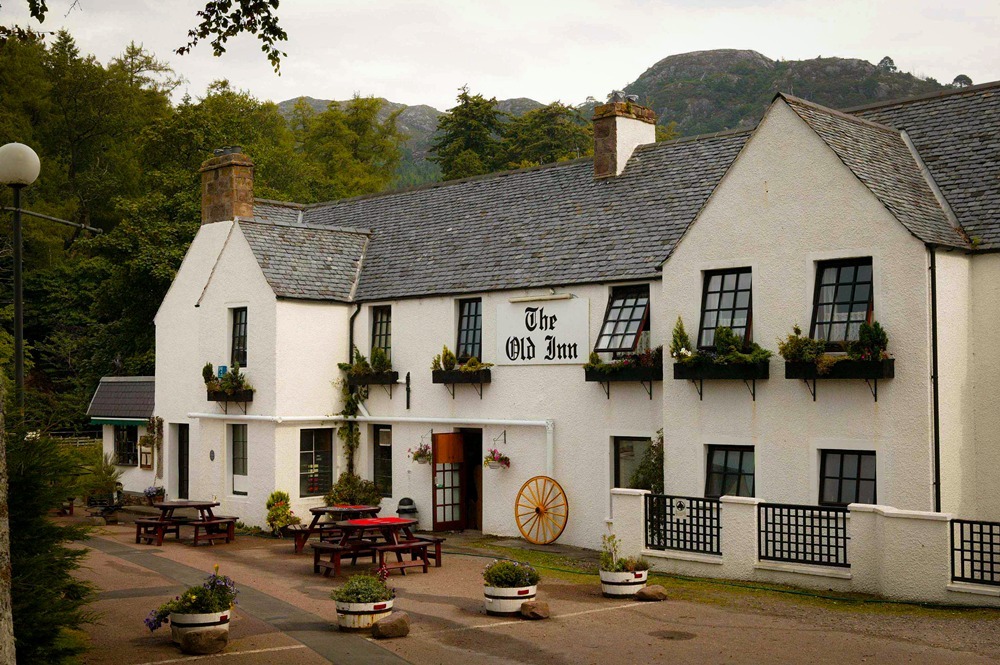 Exterior of The Old Inn in Gairloch, our award-winning sister property offering traditional Highland dining and real ales just a 5-minute walk from the Lodge.